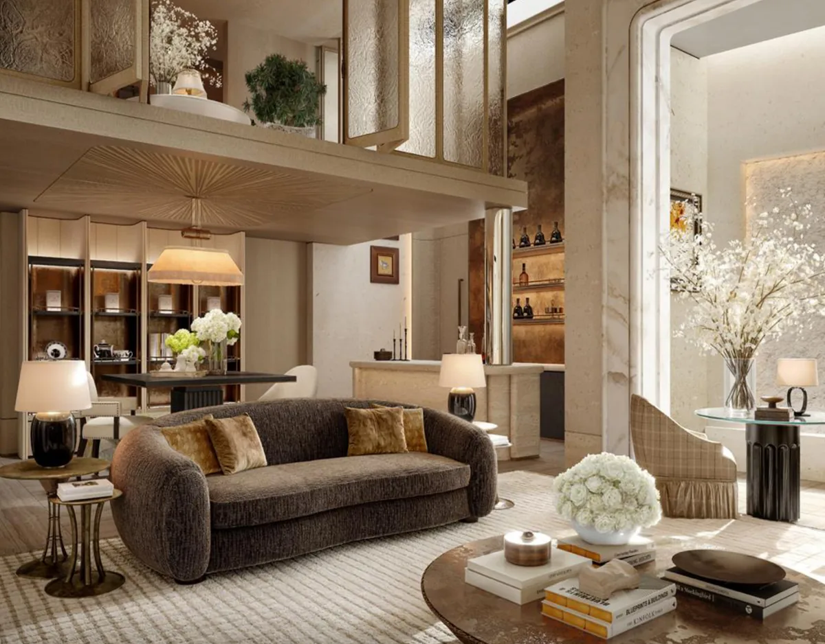 Double-height lounge with a velvet sofa, gallery shelves and blossom